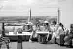 People sitting in group on rooftop Plum Skybar + Lounge