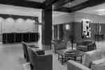 Lobby area with comfortable chairs, table and front desk