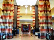 Lobby With Long Drapes, Decorative Lighting, Art Feature, and Mixed Lounge Seating