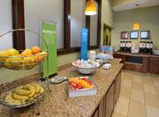 Breakfast food selections with fruit, cereals, and coffee station