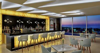 Hotel Onsite Bar with View of Sea at Dusk