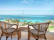 Balcony of Suite with Two Bamboo Chairs and Small Table Overlooking the Beach and the Red Sea