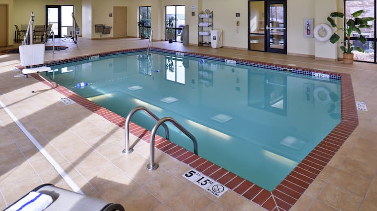 Indoor Pool With Lounge Seating and Towel Station