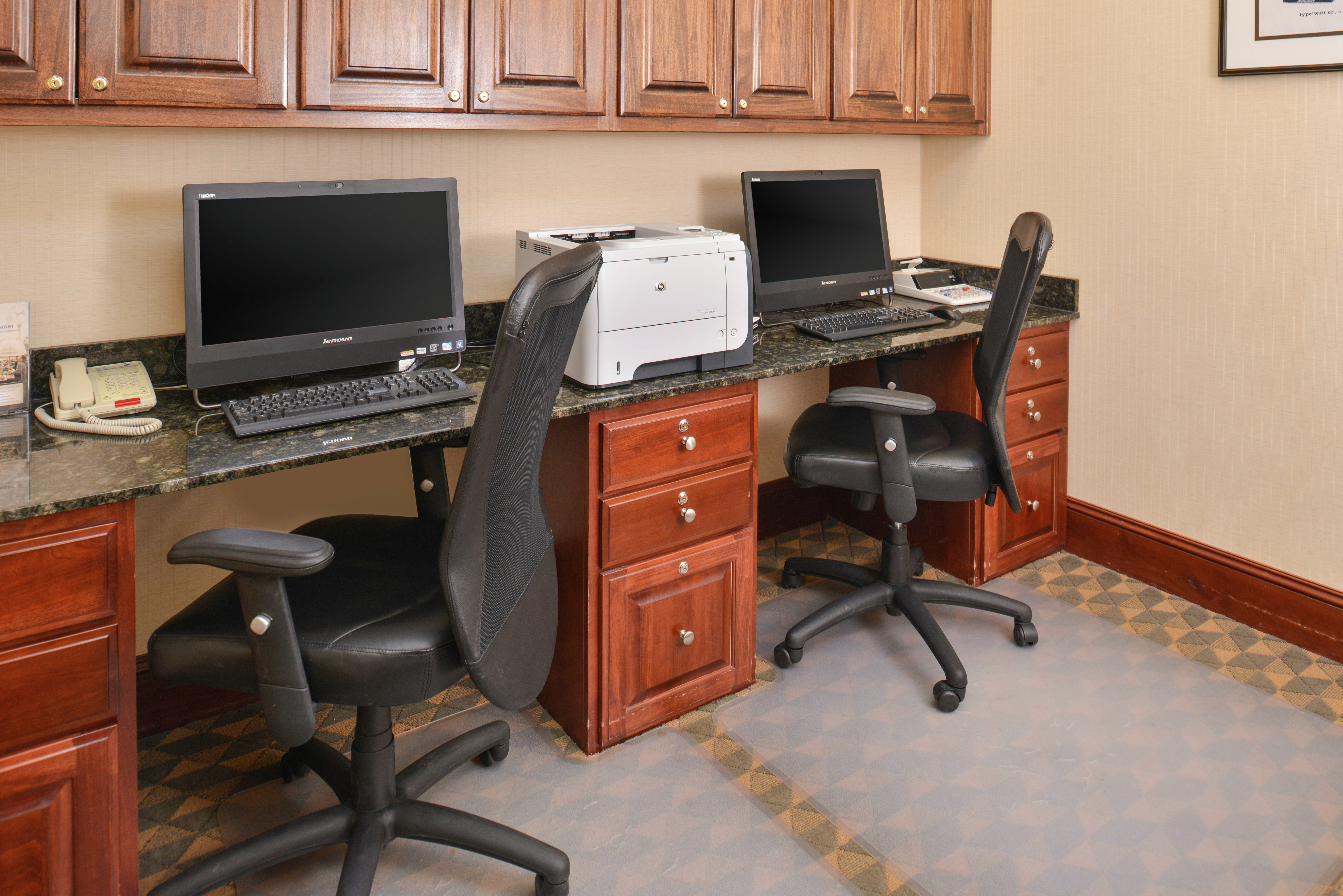 Business Center With Storage Cabinets, Two Computer Workstations, Ergonomic Chairs, Phone, and Printer