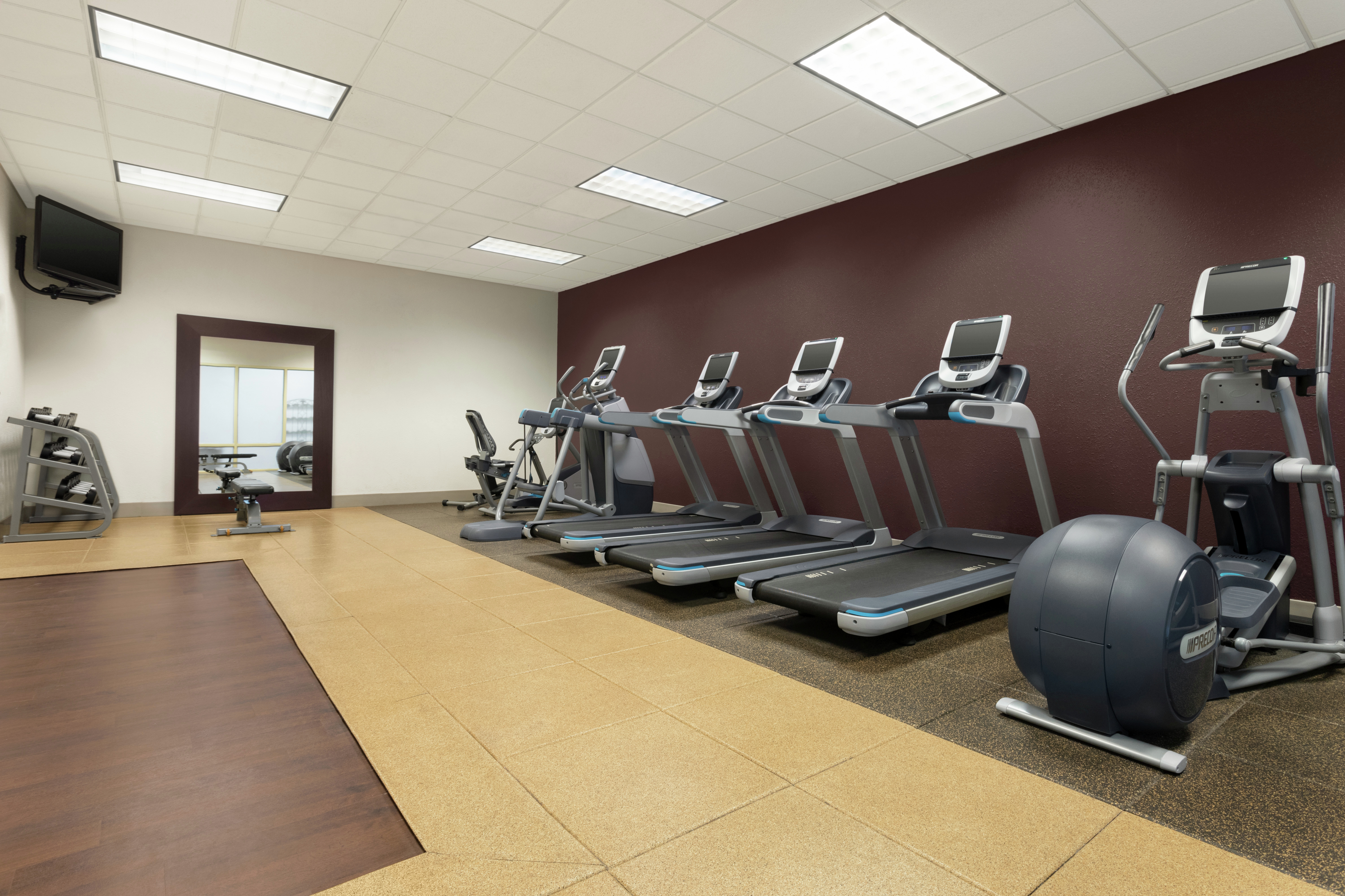 Fitness Center with Treadmills, Elliptical, Room Technology, and Mirror