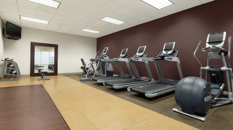 Fitness Center with Treadmills, Elliptical, Room Technology, and Mirror