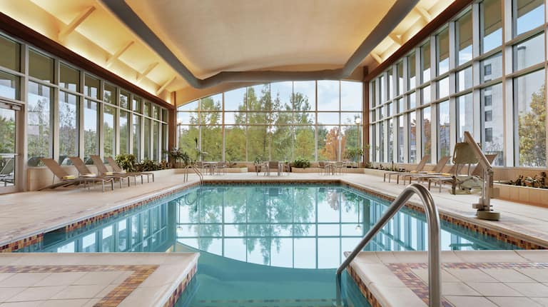 Indoor Pool with Lounge Chairs and Outside View