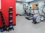 Fitness Center with Treadmills, Elliptical Machine, Dumbbells, and Basketballs