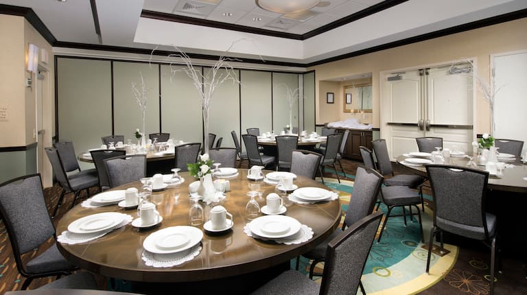 Four Round Tables With Place Settings and Seating for 32 in Meeting Room