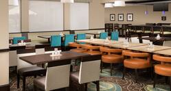 Booth and Table Seating Options With TV in Garden Grille Restaurant
