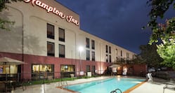 Outdoor Pool and Hotel Signage on Building Exterior