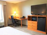 Large Bed Desk HDTV Microwave and Mini Fridge in Guest Room
