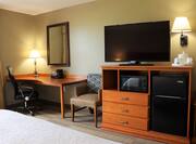 Bed Work Desk HDTV Microwave Chair and Mini Fridge inGuest Room