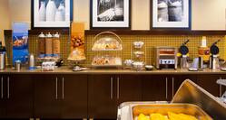 Breakfast Buffet Area with Hot Foods and Waffle Makers