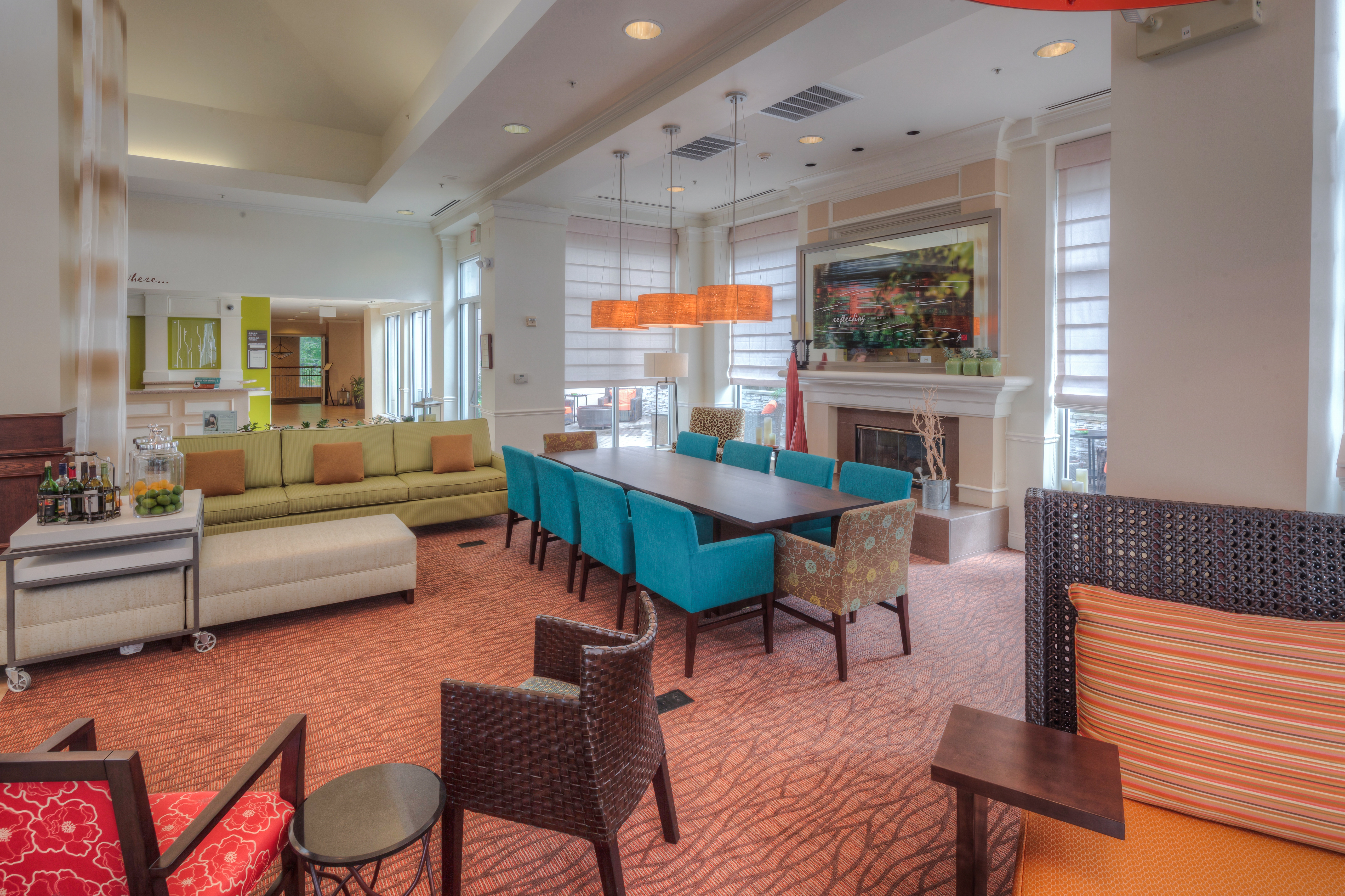 Soft Seating, Wall Art, Table With Seating for 10 by Fireplace in Lobby Lounge Area