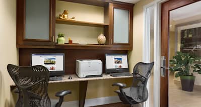 Business Center With Two Computer Workstations, Rolling Chairs, and Printer
