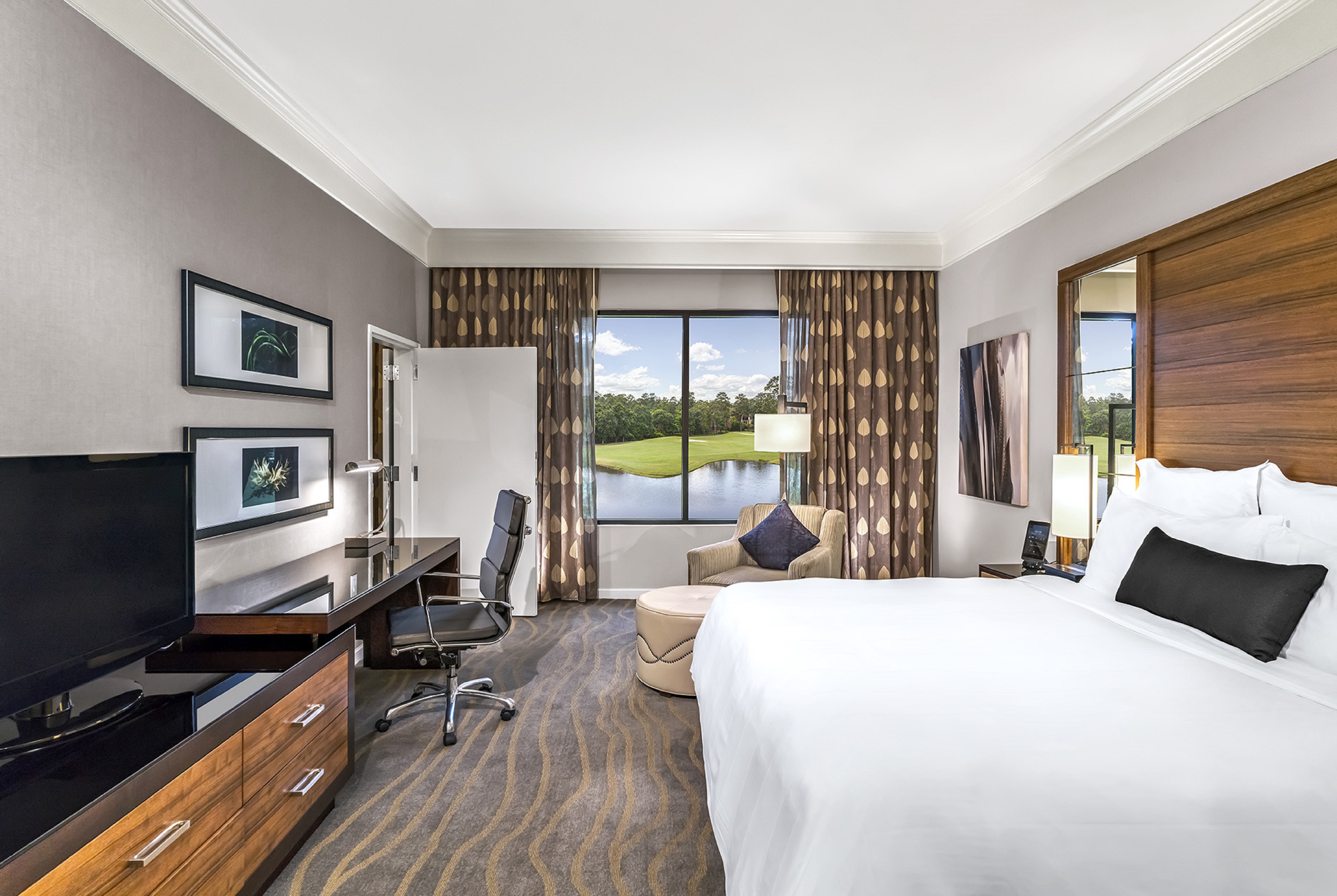 king suite bedroom with desk and golf course view