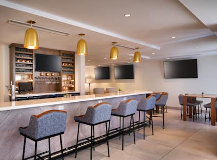 Bar Area with Four HDTVs and Chairs