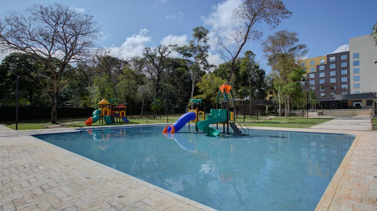 Outdoor swimming pool area with children's water slides