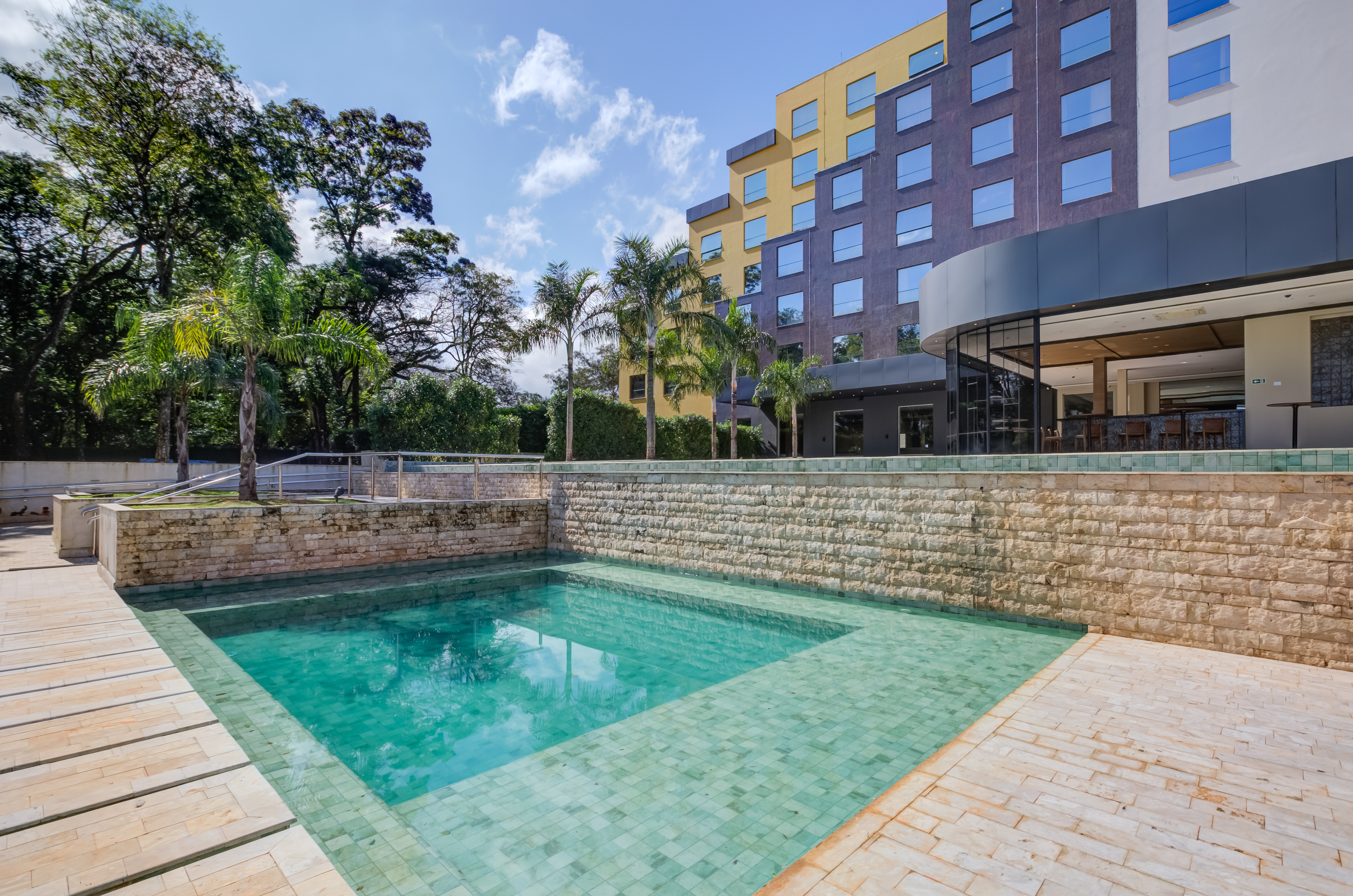 Outdoor small pool area and hotel building