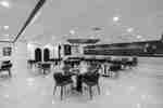 Dining sitting area with booths, and four-top tables.