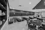 Dining sitting area with booths, and four-top tables.