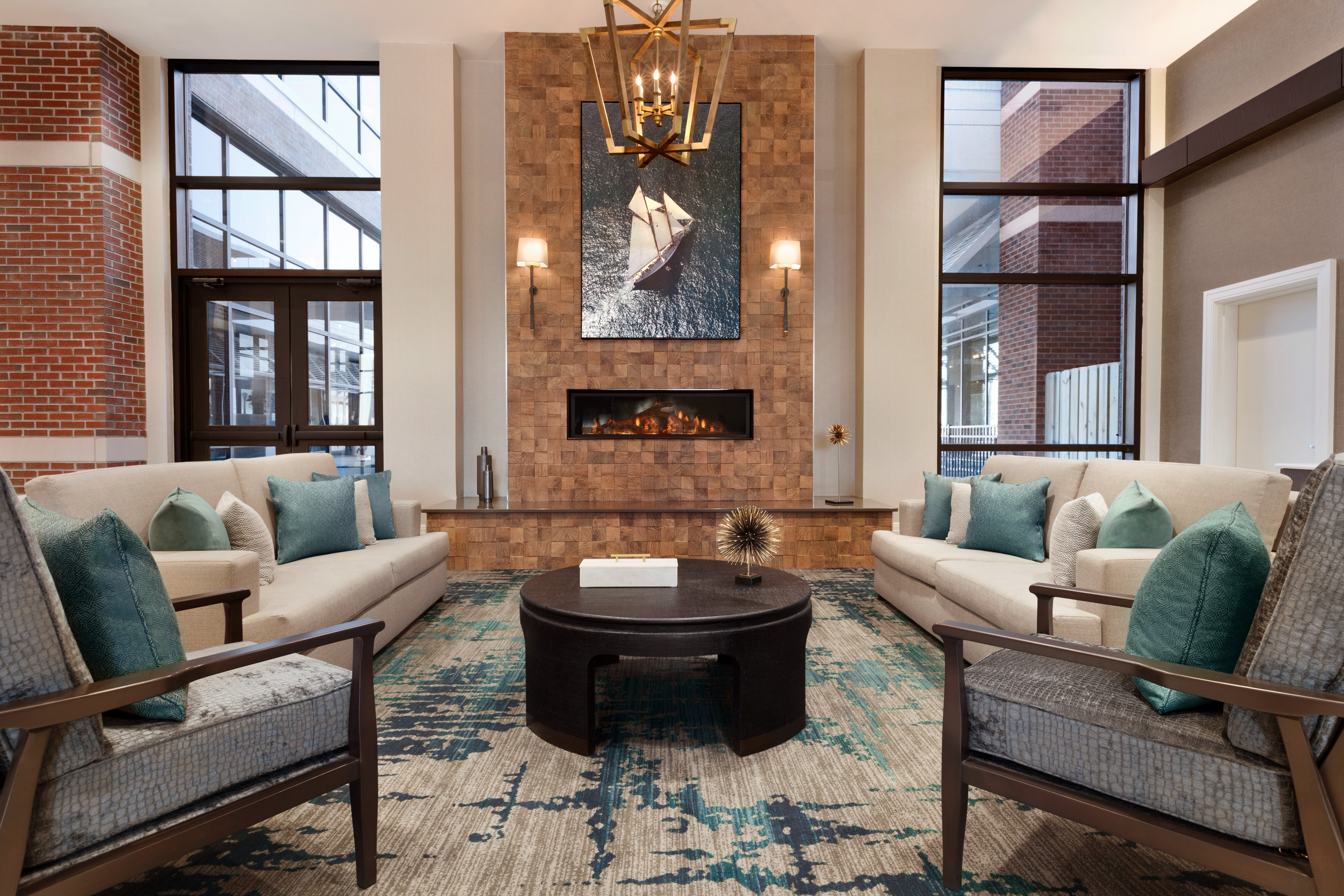 Lobby Atrium Seating Area with Sofas, Coffee Table, Armchairs and Fireplace