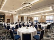 Spacious Ballroom with Round Tables and Chairs