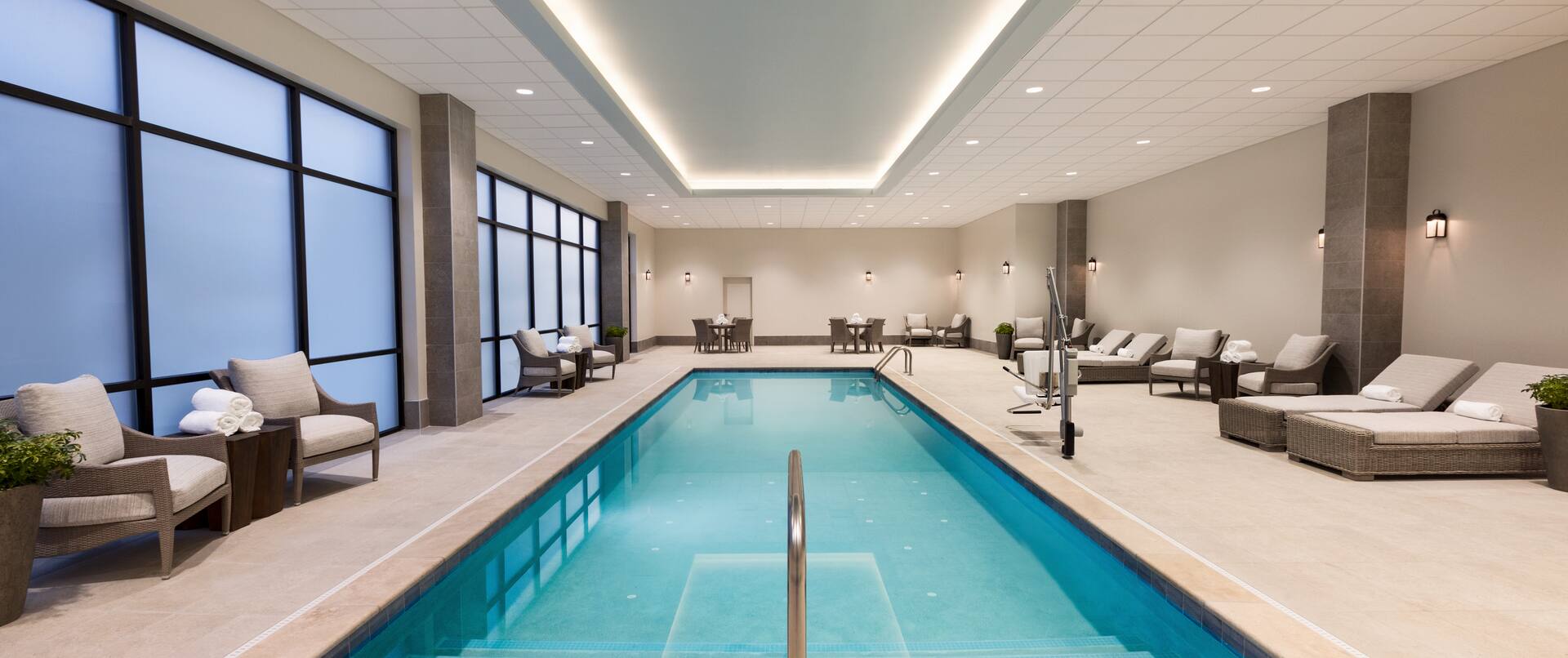 Indoor Swimming Pool with Armchairs and Deck Chairs