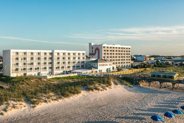 Aerial view from over the ocean of the exterior of the hotel.
