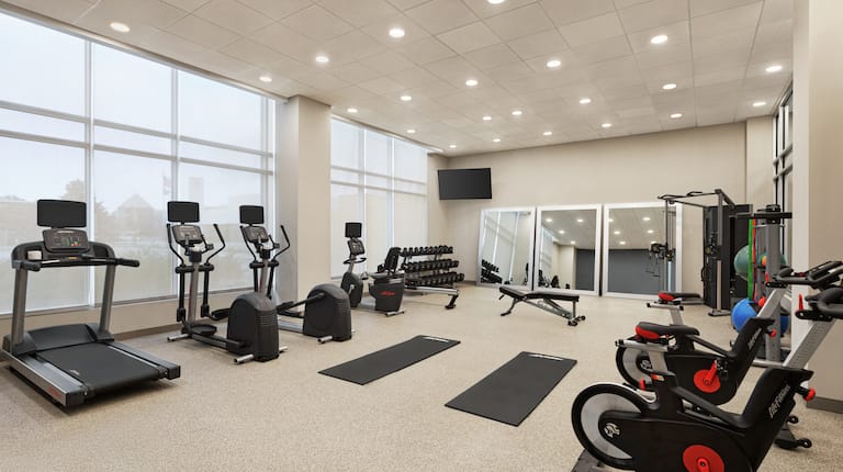 Convenient on-site fitness center featuring ample space, cardio machines, and free weights.