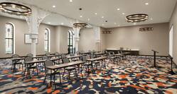 Spacious on-site meeting room featuring stunning stained glass windows, classroom setup, and refreshment station.