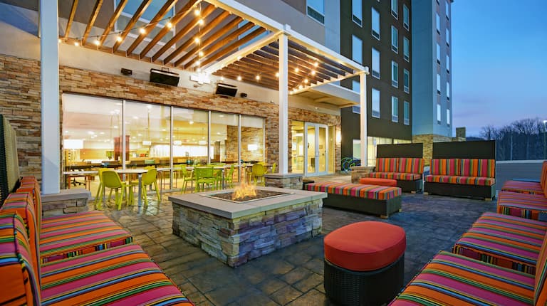 outdoor patio with seating and fire pit at dusk