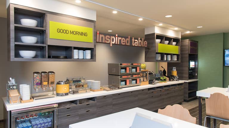 Signage Above Breakfast Counter with Hot and Cold Foods and Counter Style Seating