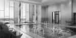 Indoor Swimming Pool With Deck Lounge Seating and Large Windows