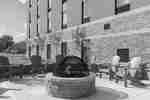 Chairs Around Fire Pit on Outdoor Patio by Hotel Exterior