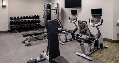 Fitness Center with Cycle Machines, Weight Bench, Weight Machine and Dumbbell Rack