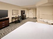 Whirlpool, King Bed, TV, Work Desk, Hospitality Center, and Entry in Suite