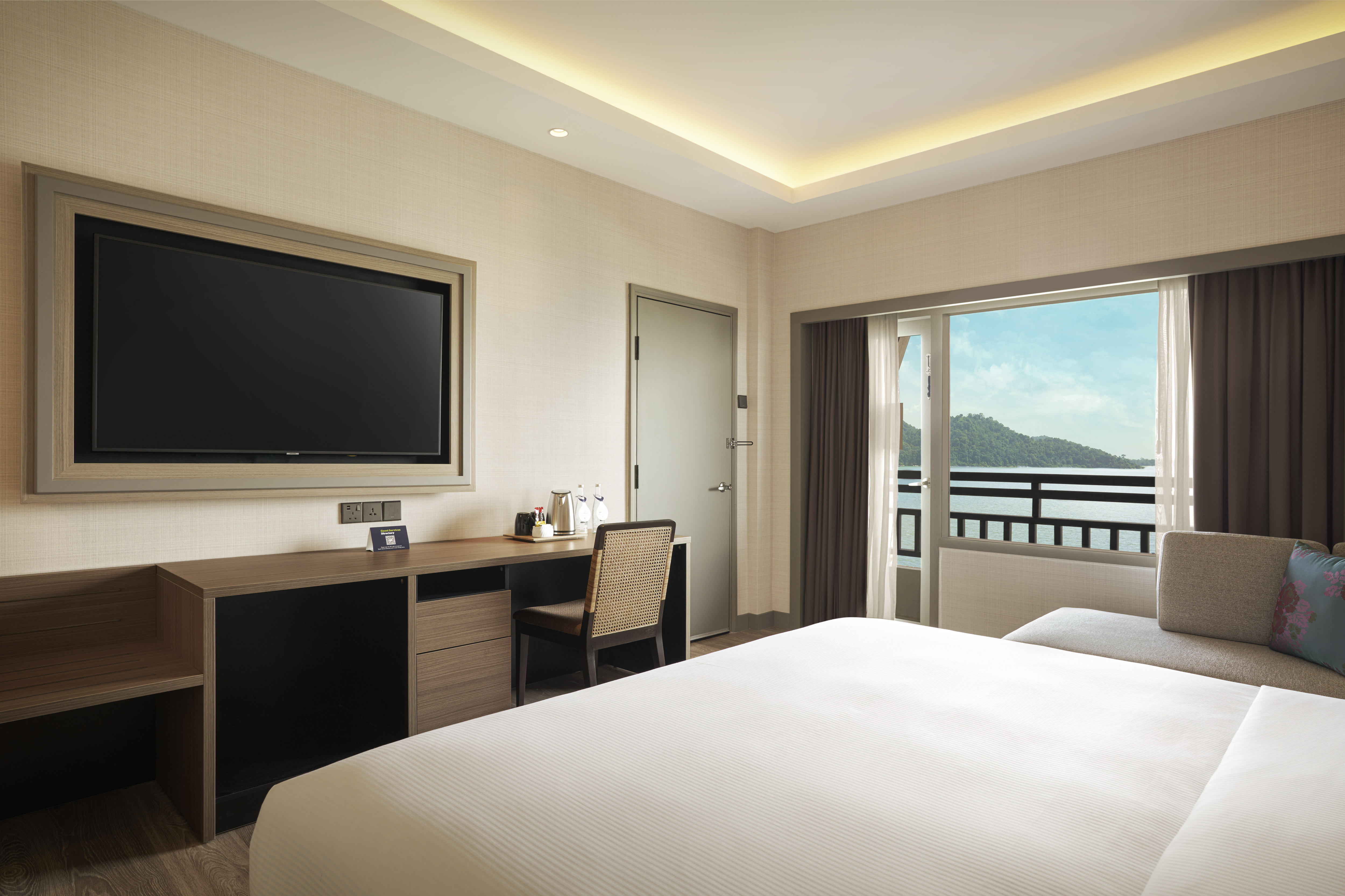 King suite bedroom with wall mounted TV and sea view