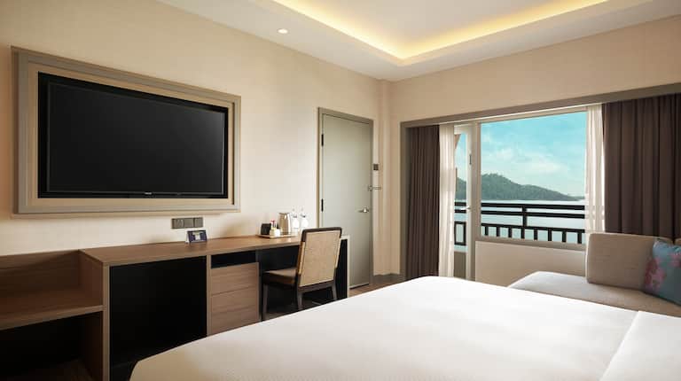 King suite bedroom with wall mounted TV and sea view