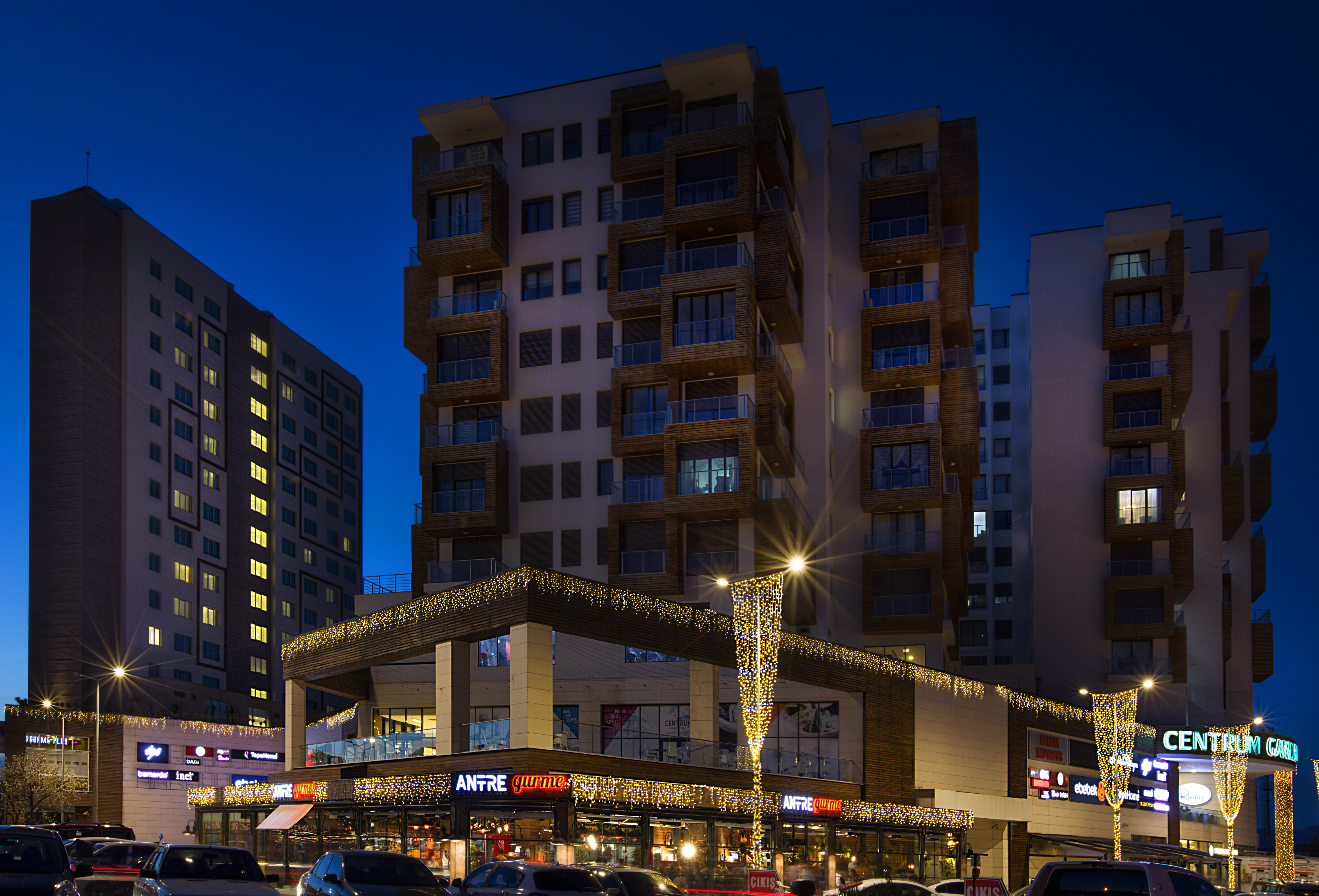 Hotel Exterior and Adjacent Businesses at Night