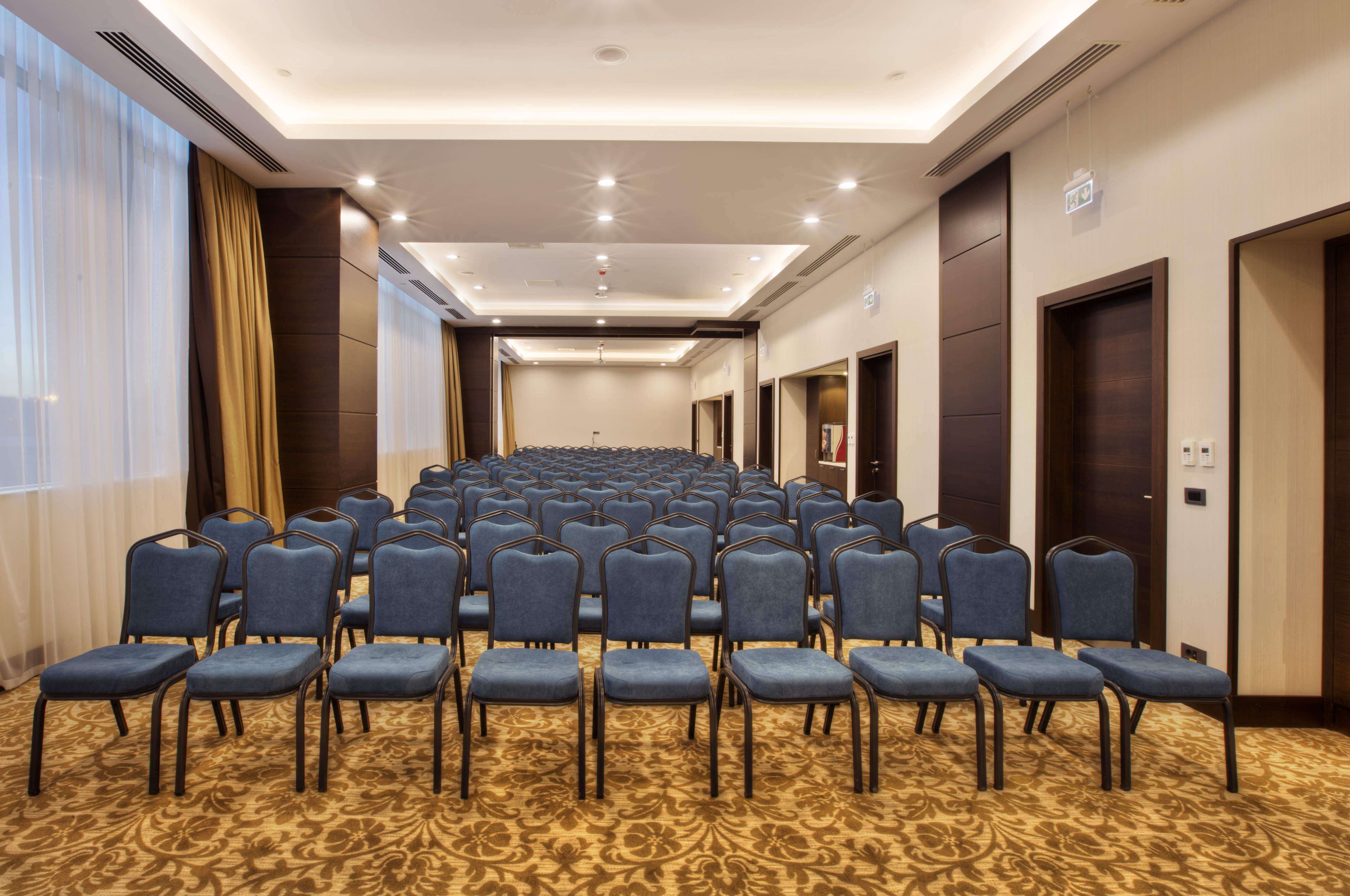 Lavandula Meeting Room Arranged Theater Style With Rows of Blue Chairs Facing Podium