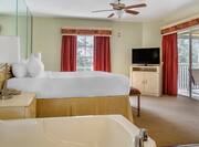 King suite bedroom with TV and whirlpool tub