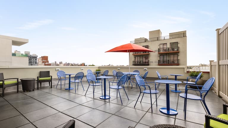 A view of the spacious roof top patio, with contemporary, colorful patio furniture