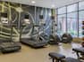 Convenient on-site fitness center fully equipped with cardio machines, medicine balls, and workout benches.