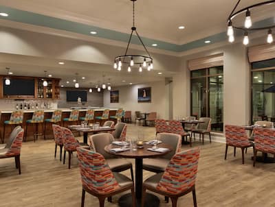 Spacious on-site restaurant featuring welcoming atmosphere, stylish design, and delicious food and drink.