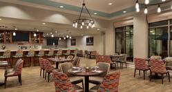 Spacious on-site restaurant featuring welcoming atmosphere, stylish design, and delicious food and drink.