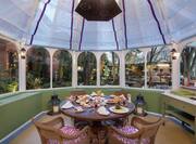 Green House Garden Restaurant with Round Table and Chairs