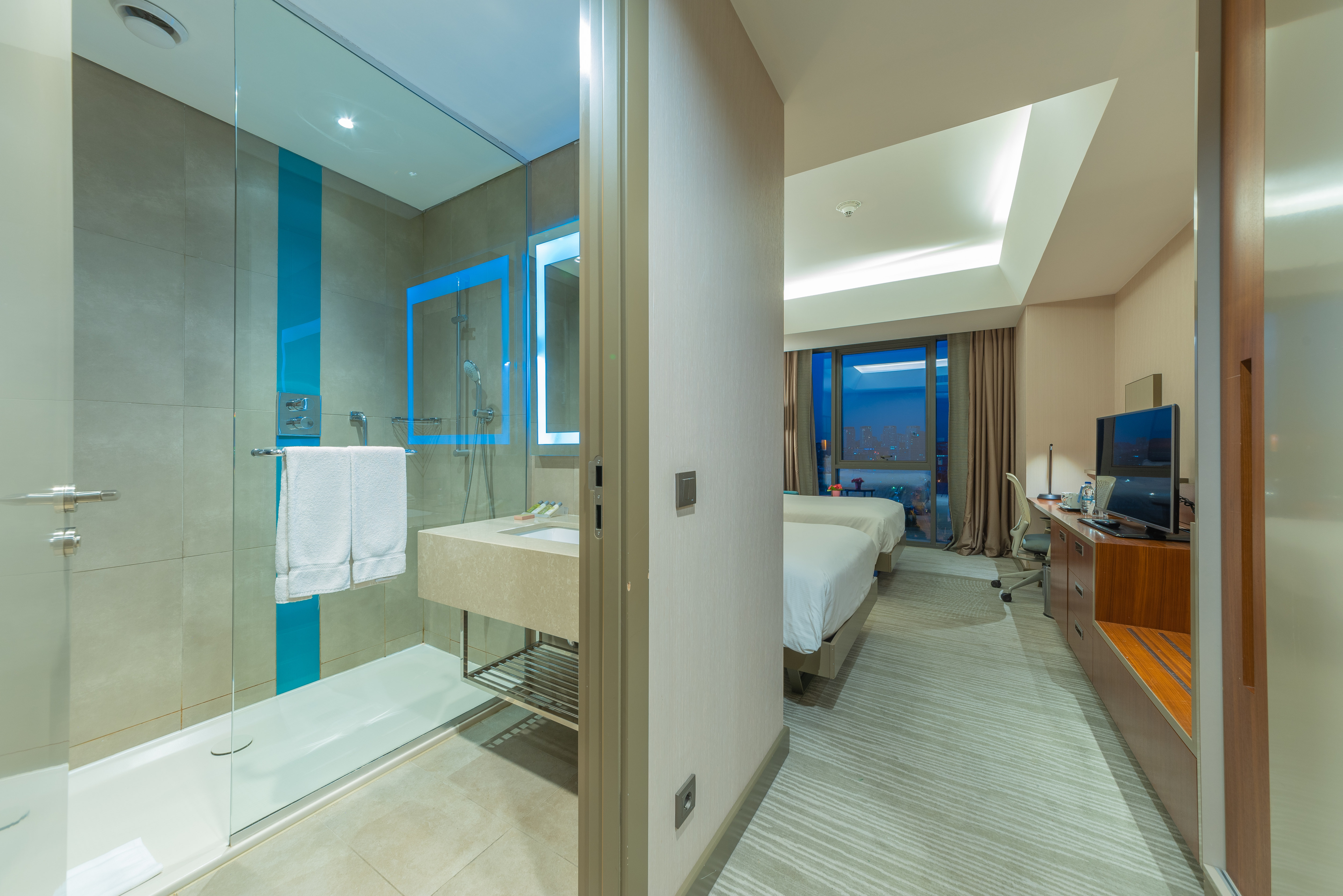 view of bathroom with shower and bedroom
