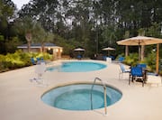 Outdoor Pool and Hot Tub with tables, umbrellas and chaise lounge seating